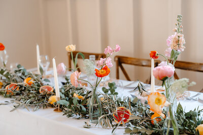 Wedding breakfast table centerpieces and reception floral arrangements at Hyde House